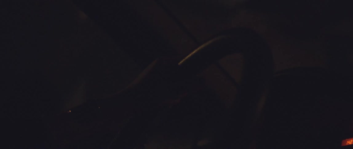 A person holding the steering wheel of a car while driving