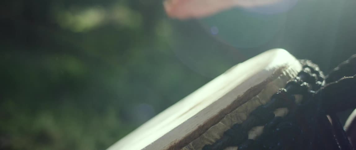 Hands of someone beating drum during the day