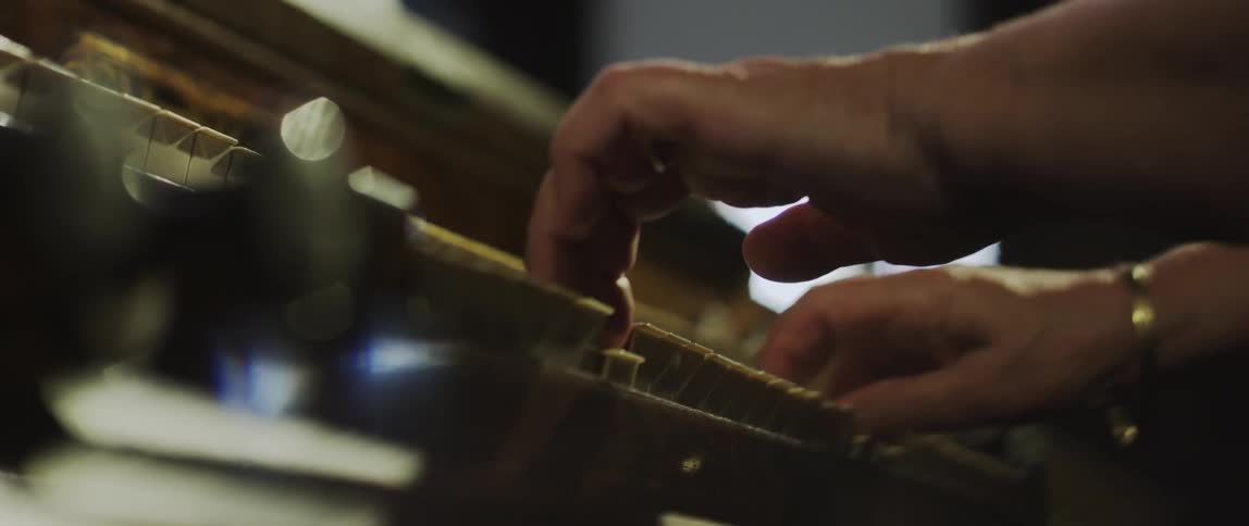 Hands of a woman playing the piano