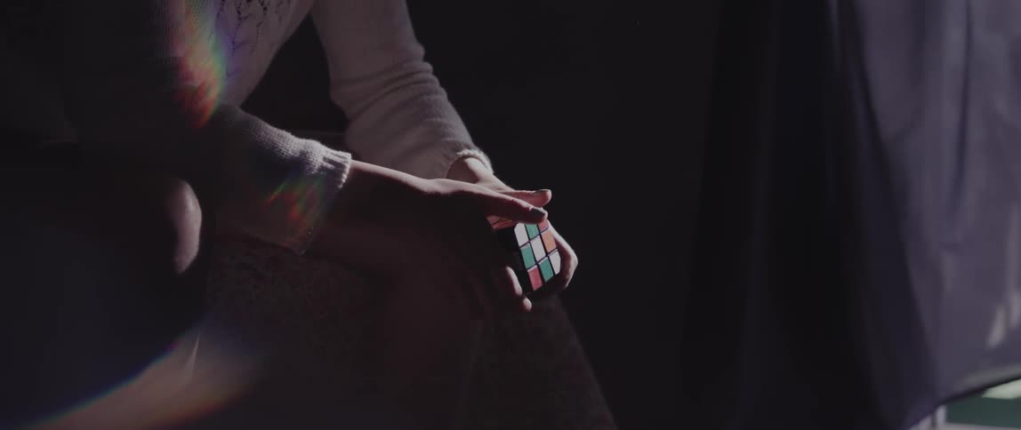 A person trying to solve a rubiks cube