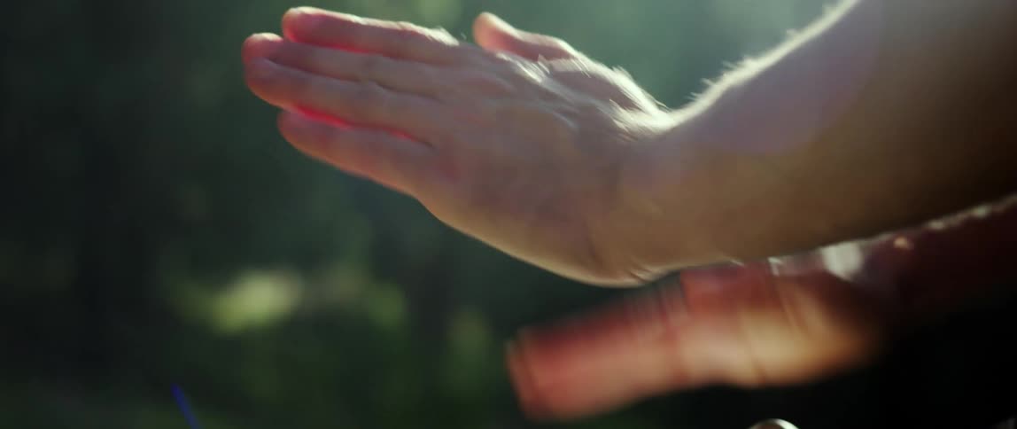 Closeup of a persons hands playing a drum