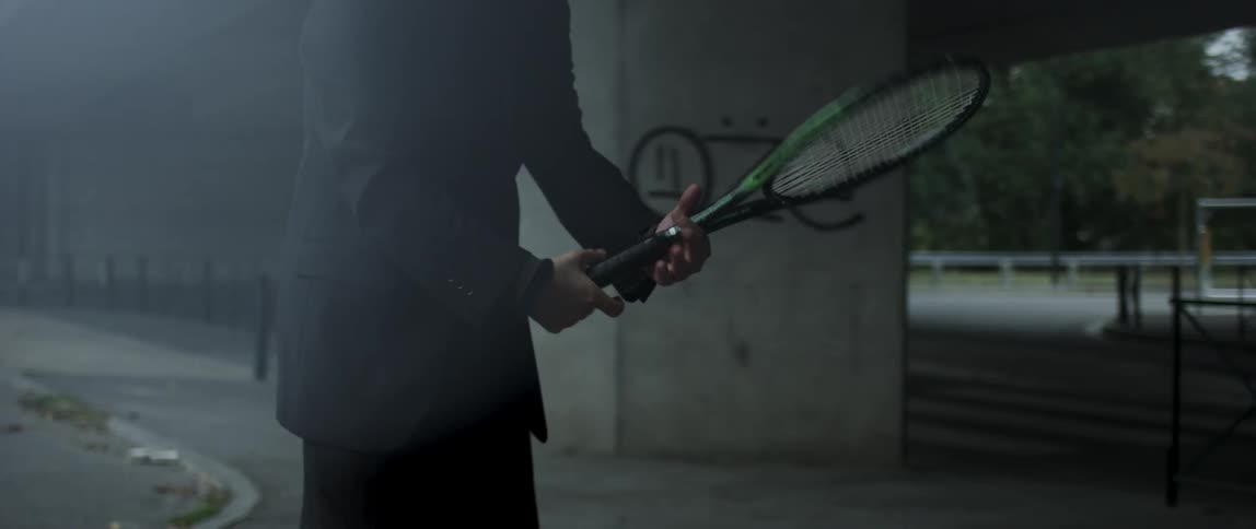 A man spins a tennis racket in his hand