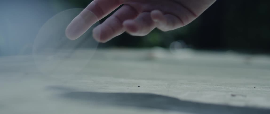 A person playing dice on the floor