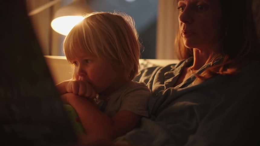 A mother reading a story to her daughter