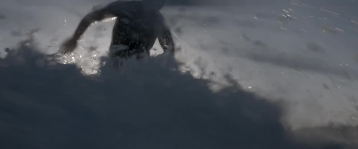 A man is surfing in the water on a sunny day
