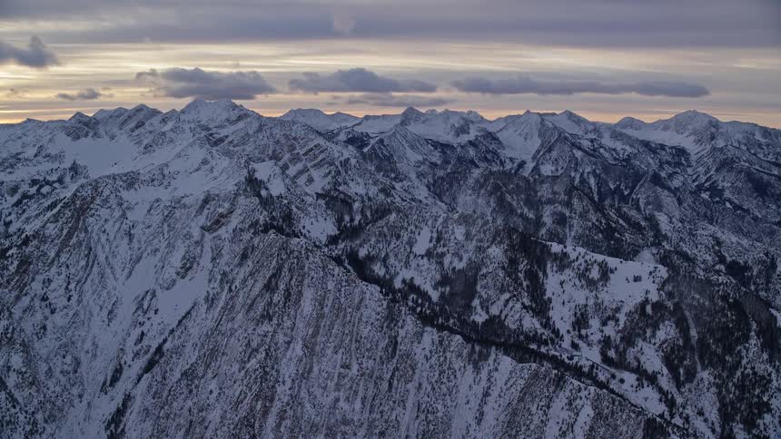 An aerial view of a region with snowcapped mountains