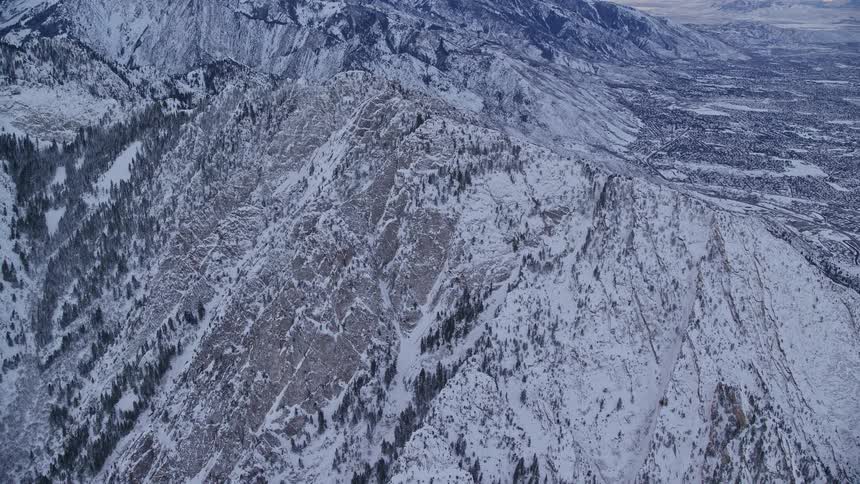 An aerial view of a region with many snowcapped mountains