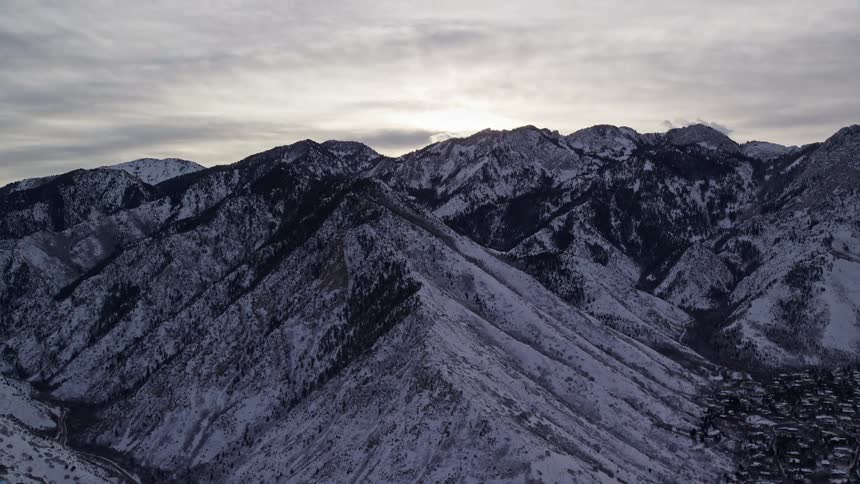 Aerial view of a snowy mountain range at morning
