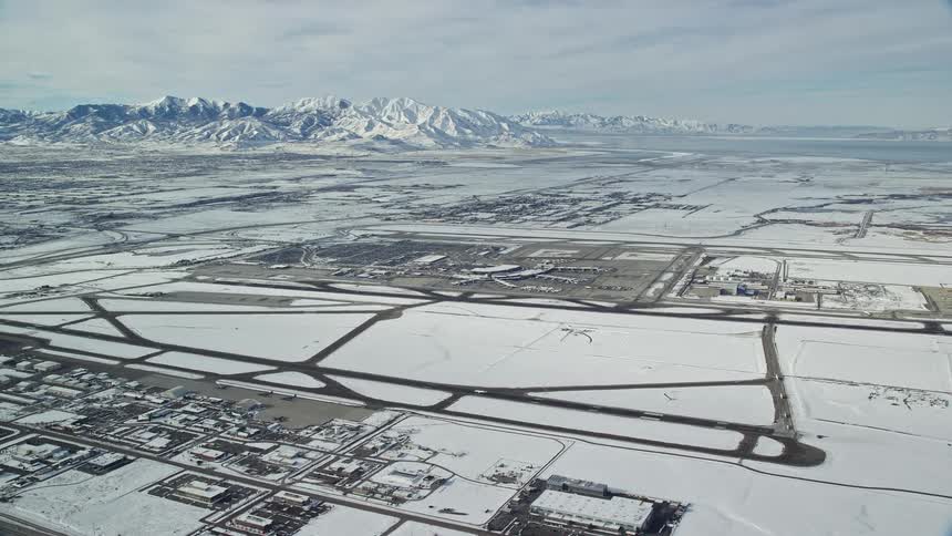 Aerial of a snowcovered airport as a plane takes off