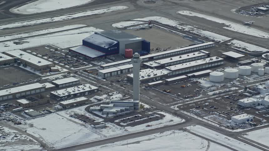 Skyline of an airport with a plane taking off during winter