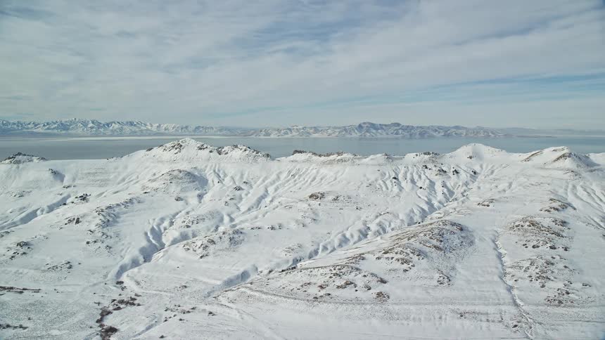 Aerial panorama of snowcovered mountains by the sea
