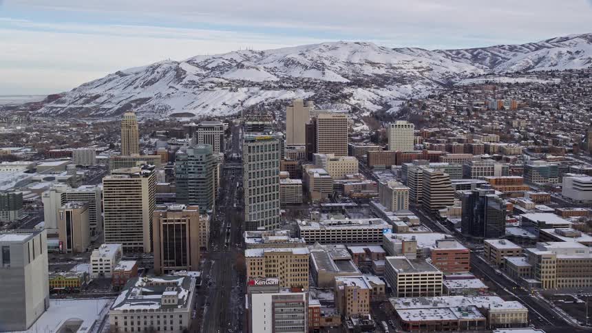 Skyline of an urban city with ice mountains in the background