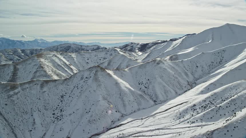 Aerial of glacial mountain range during harsh winter
