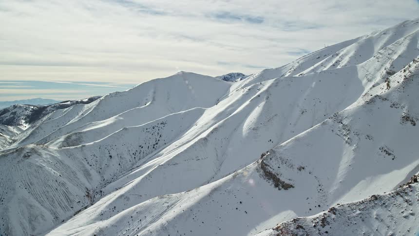 Aerial panorama of mountains and peaks covered in snow