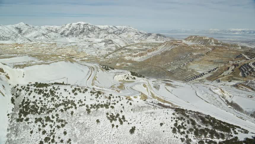 Aerial view of snow covered mountains and valleys during the day
