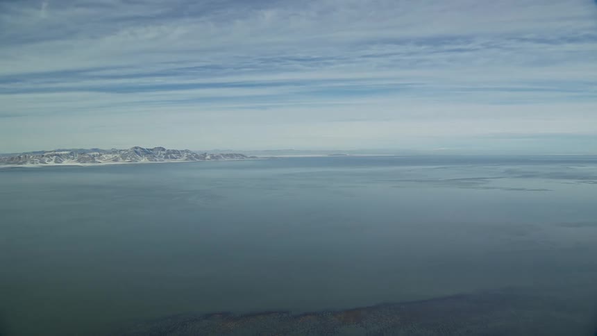 Aerial view of the snowcovered coastline next to the ocean