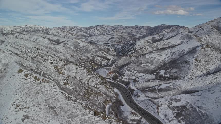Aerial view of a road in the middle of a snowcovered mountain range