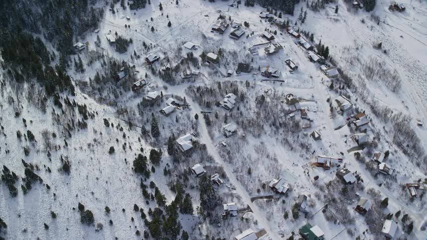An aerial orbiting clip of a rural community during winter