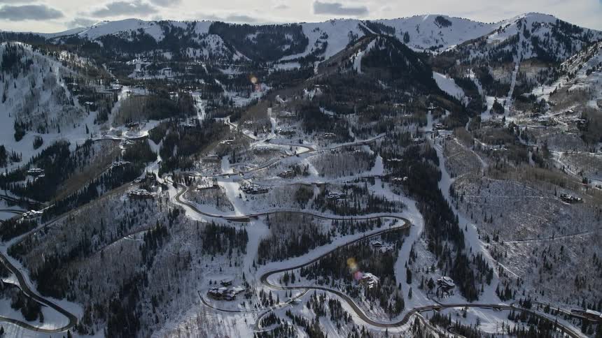 Aerial of the hill with small houses covered in snow