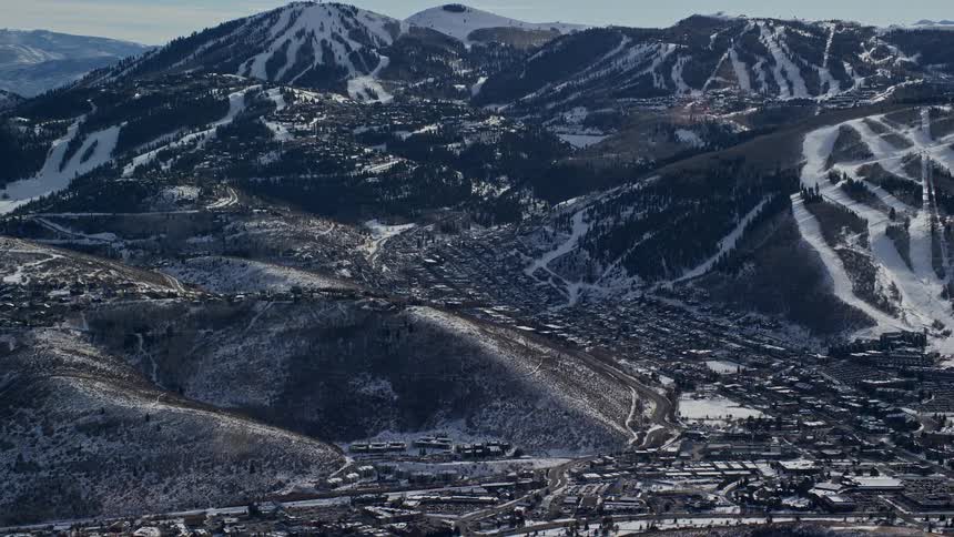 The mountains and town are covered with snow