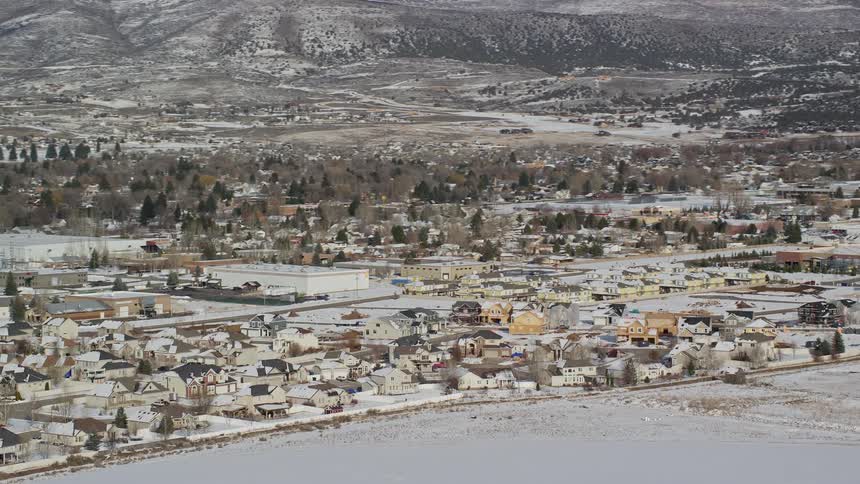 Panorama of a city with residential houses covered in snow and intersections