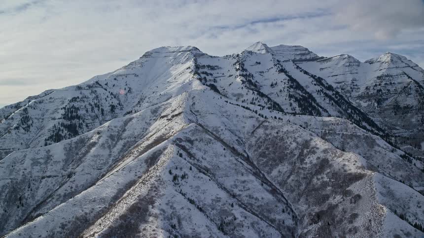 Aerial of a frozen mountain range during winter day