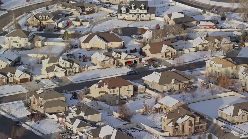 Aerial of a residential neighborhood with snowcovered houses