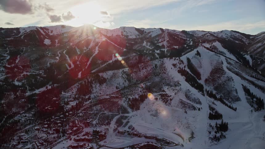Aerial landscape of mountains and peaks covered in snow with the morning sunlight