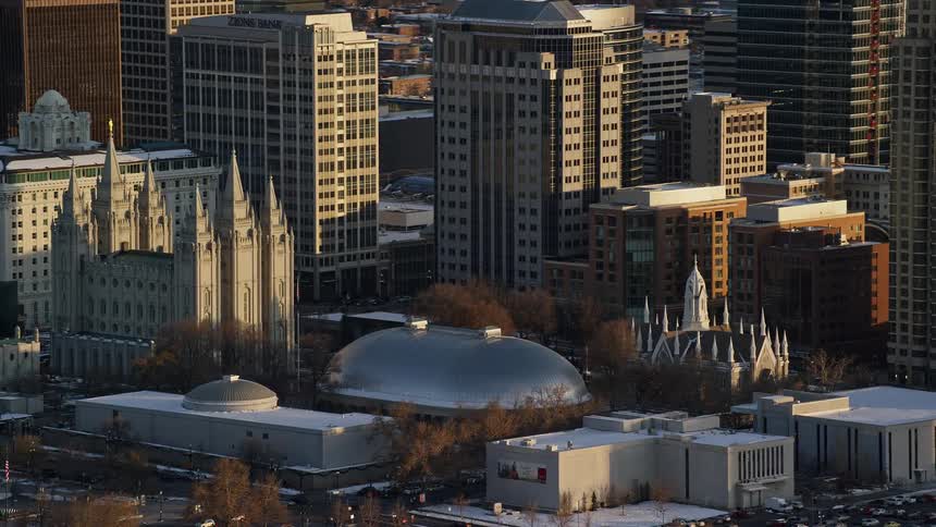 Aerial of downtown salt lake city temple square half brightly lit by sunlight half shadowed in the winter