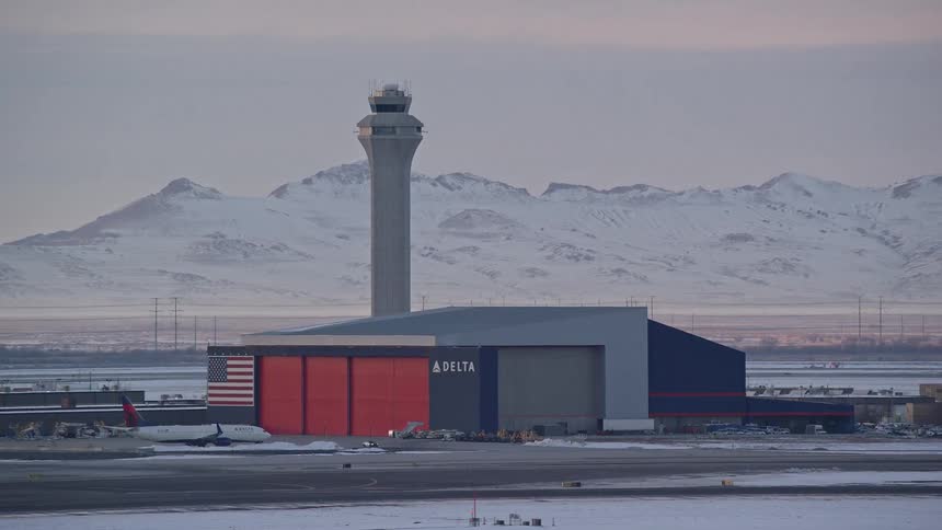 Airline building at an airport with aircraft parked on the runway