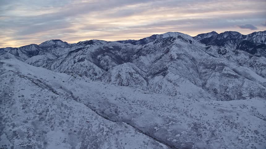 Panorama of a snowcovered mountain range under a morning sky