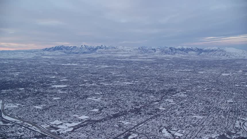 An aerial view of a city with cold weather and lots of snow on the ground