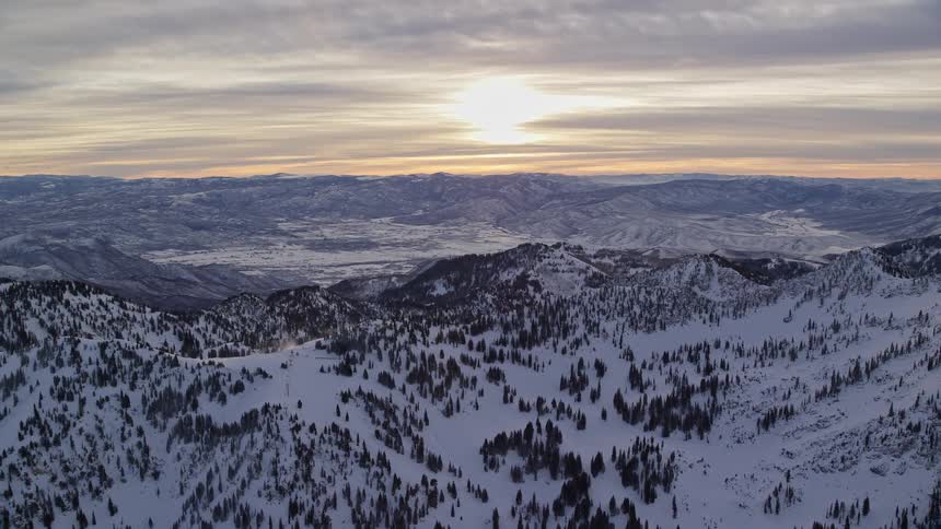 Skyline of a mountain range covered in snow during winter
