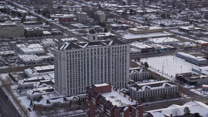 Aerial view of a large building in a city during a snowy winter day