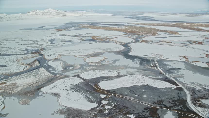 Aerial panorama of rivers and land covered in snow