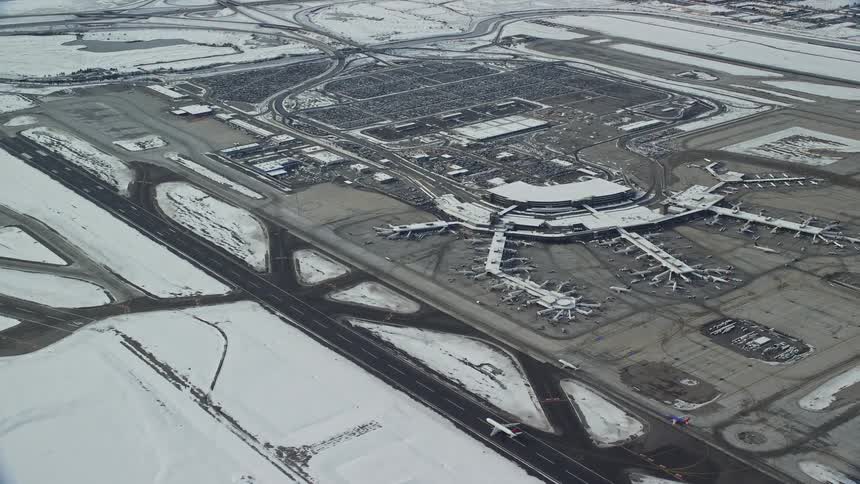 Skyline of an airport with aircraft landing during winter