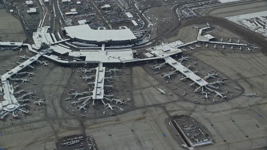Skyline of an airport with planes parked in the apron