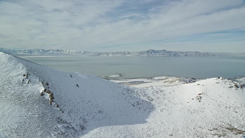 Panorama of snowcovered mountains facing the sea