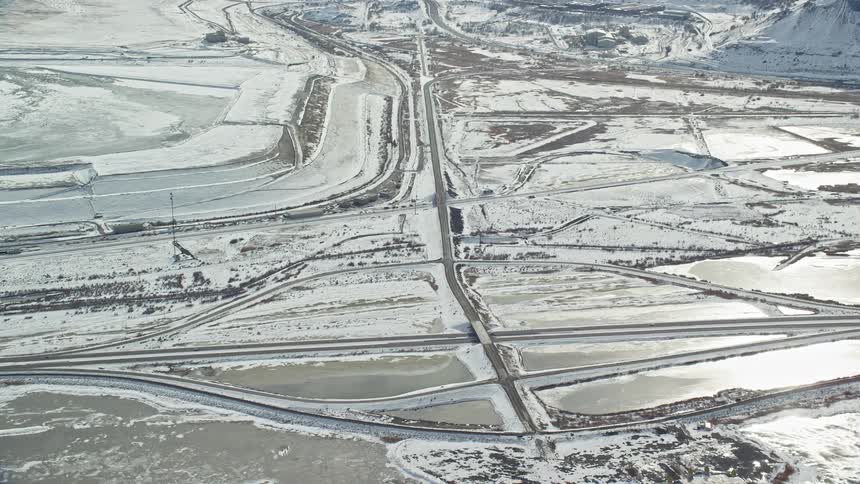 Aerial of snowcovered highway in a desert landscape