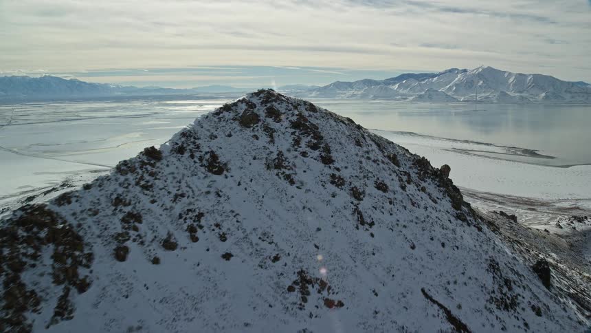 A region with mountains and a large snowfilled lake around