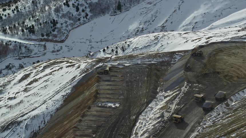 Aerial view oftrucks driving in bingham canyon mine