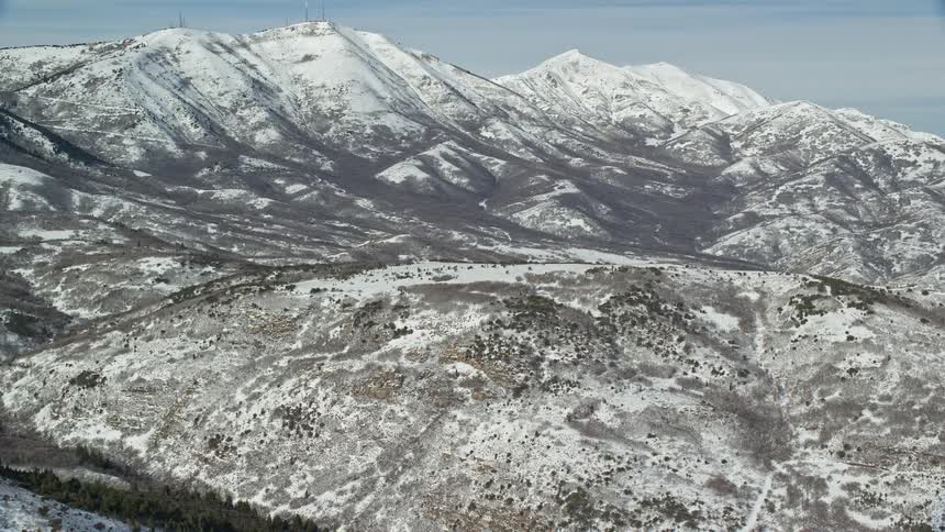 Panorama of a mountain range covered in snow on a cloudy day
