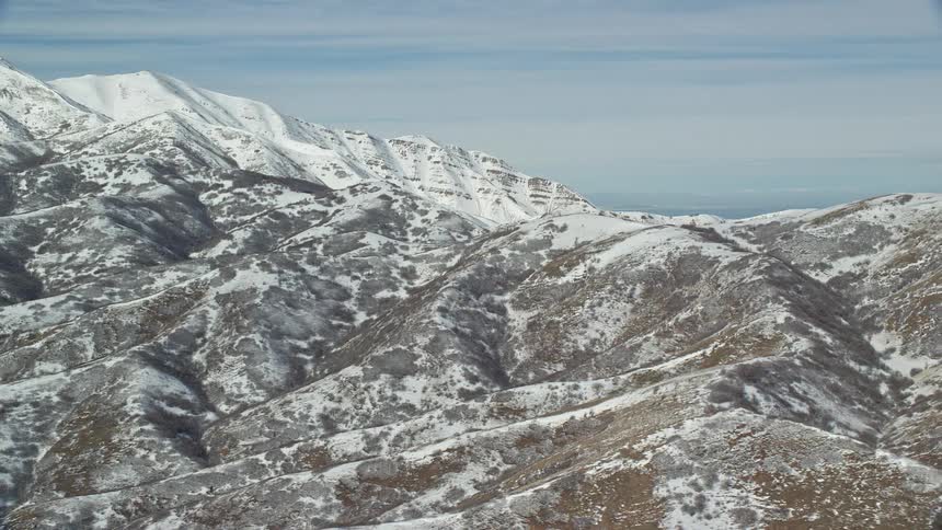 Aerial panorama of a mountain range covered in snow
