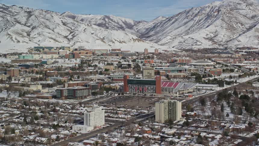 Aerial view of a city next to the mountains at winter