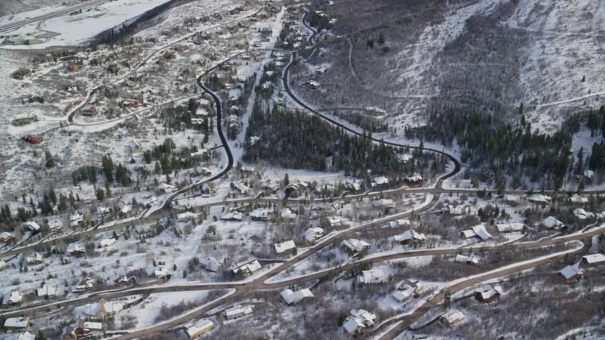 Aerial view of a residential neighborhood next to a snowcovered mountain