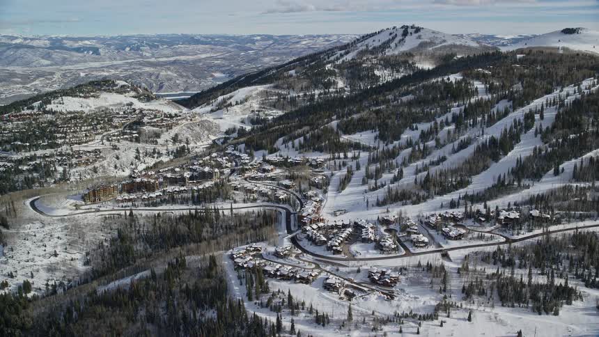 Aerial of a neighborhood with snowcovered houses on a hill