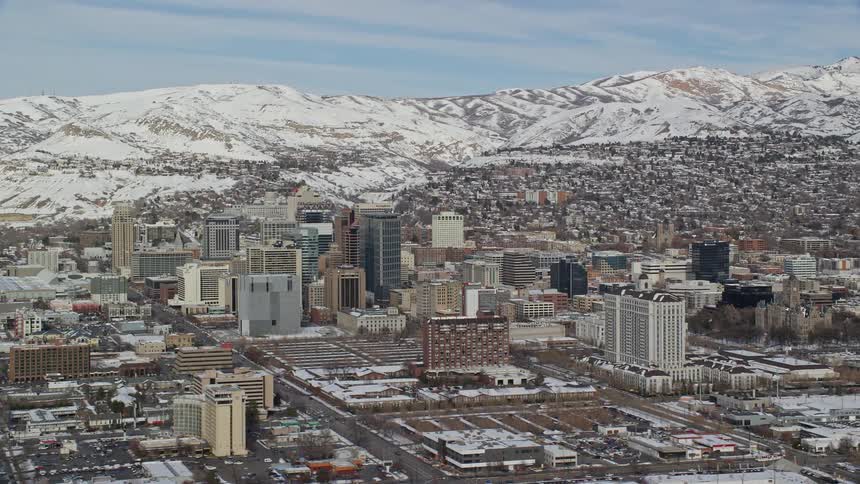 Skyline of a small urban town with glacial mountains on the horizon