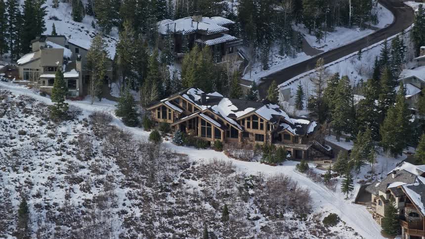 Aerial view of a snowcovered residential neighborhood with various mansions and houses