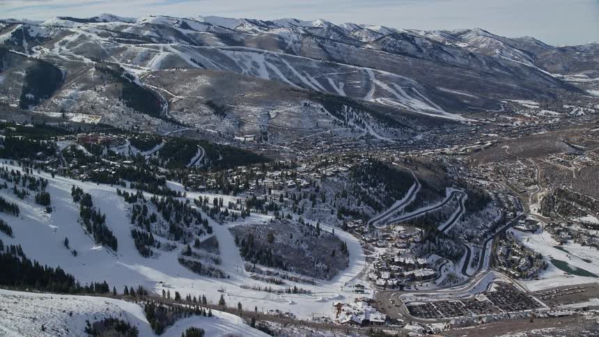 An aerial view of a rural town with snow in the surroundings