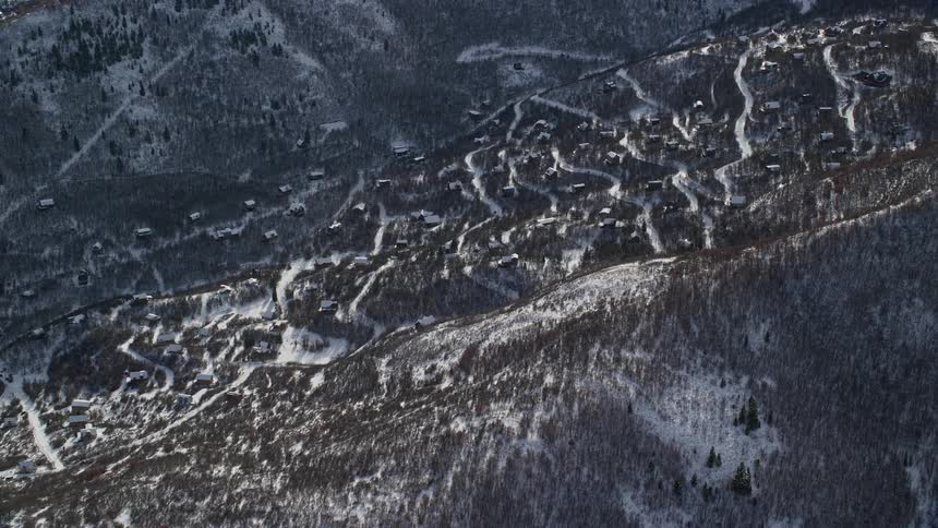 An aerial view of buildings nestled in a snowy valley